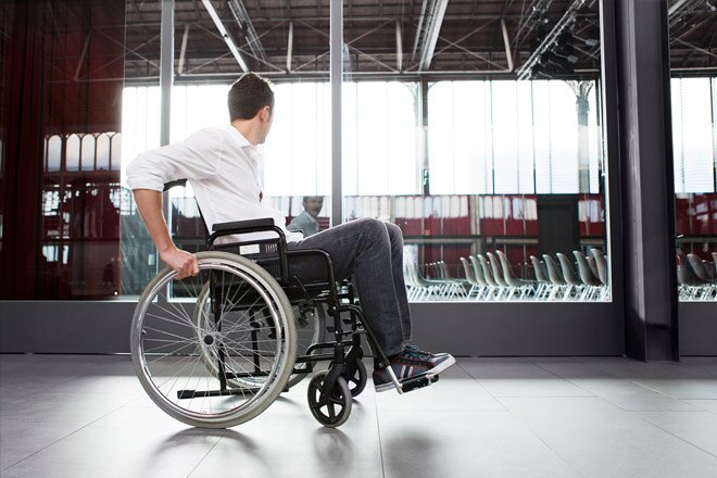Man using wheelchair through terminal