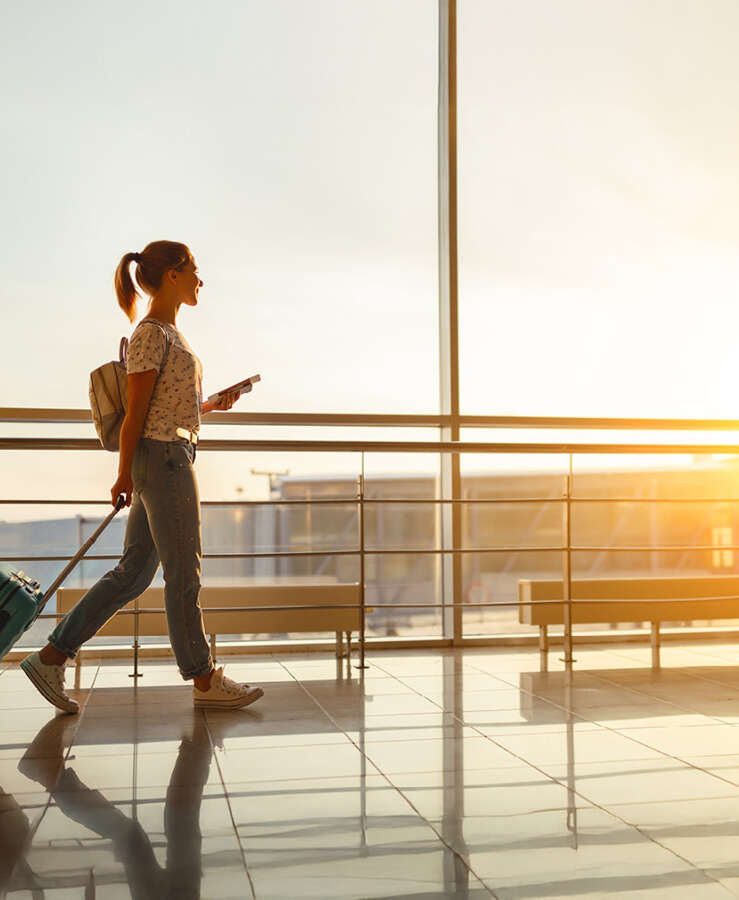 Women walking in terminal with carryon baggage