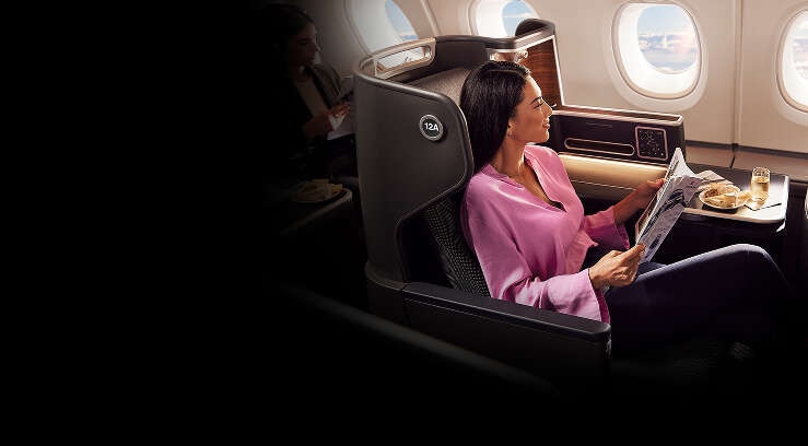 Female sitting in Business on A380 reading magazine