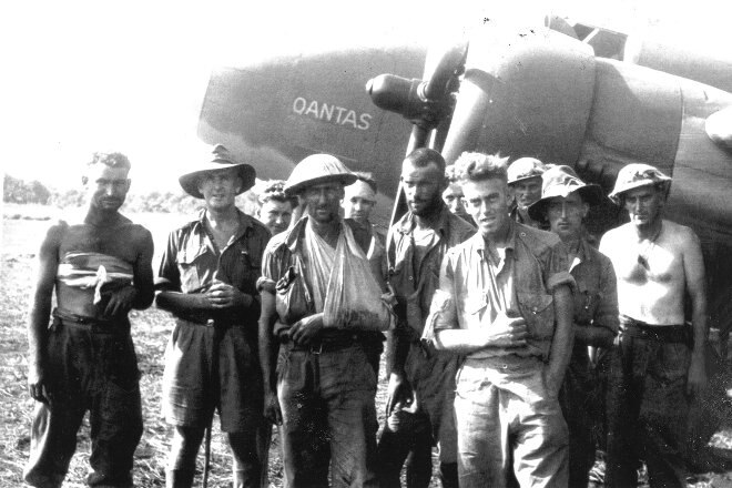 WW2 soldiers in front of a Qantas aircraft