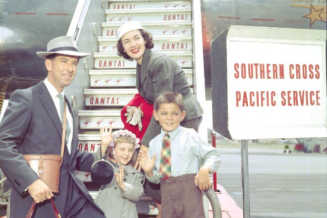 Family in front of Qantas aircraft boarding