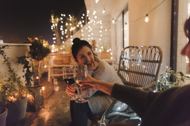 Two people cheers with glasses of wine