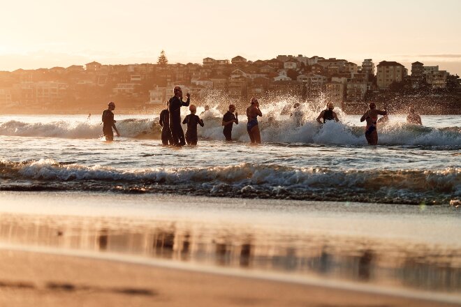 People heading into the surf