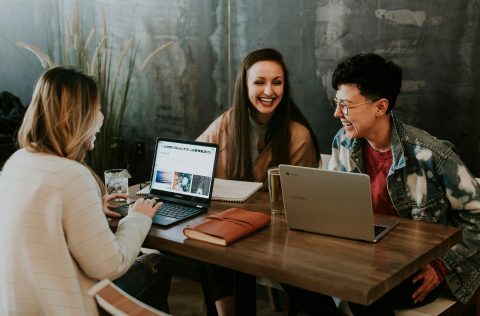 Group of colleagues working around laptops