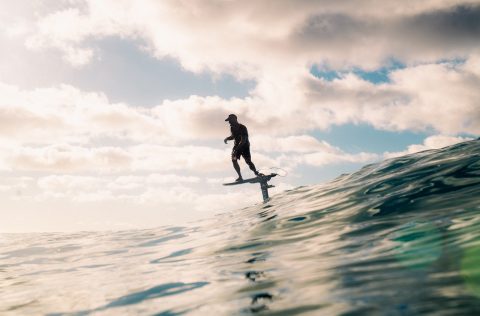 Surfer in the ocean on a Foil Drive