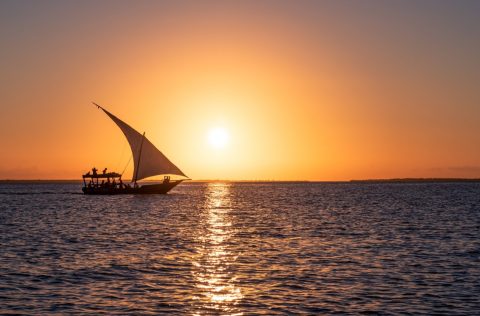 A sailboat off the coast of Zanzibar at sunset