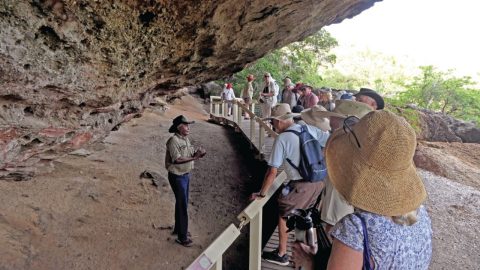 Ranger Danny Gordon shows tourists indigenous rock art on Stanley Island