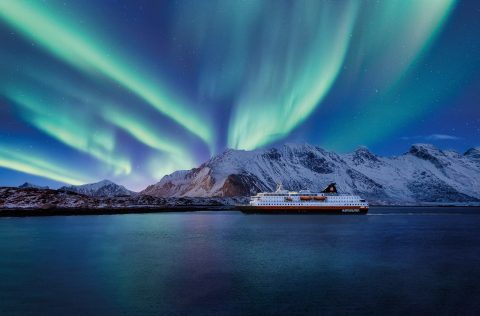 MS Trollfjord sailing under the Northern Lights