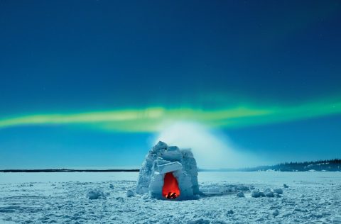 An igloo under the Northern Lights in Yellowleaf, Canada
