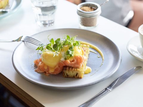 A round dish with a blue rim containing golden mounds of scramble egg