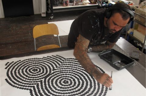 Otis Hope Carey working in a studio at China Heights Gallery, Sydney